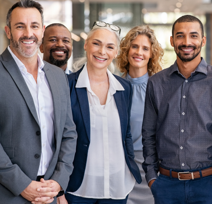 4 Employees together smiling in an office